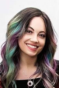Jessica, stylist at Glamology Lounge, with vivid teal, purple, and magenta in her hair. Portrait by Fall Child Photography.